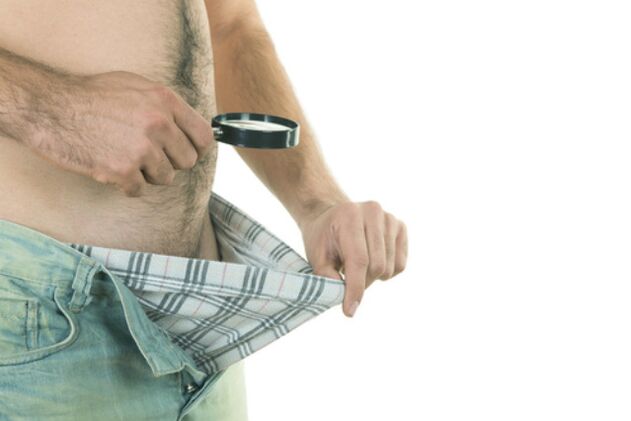 A man looks at his penis and wants to enlarge it
